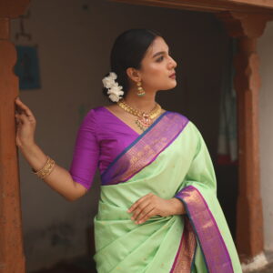 Sailaja mint green silk saree with purple magenta zari border and pallu.