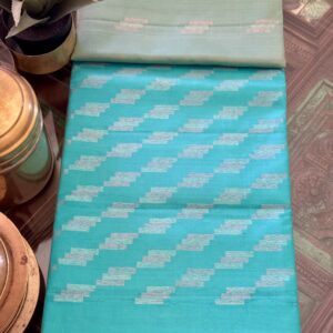 Turquoise handloom silk saree with silver zari geometric step patterns.