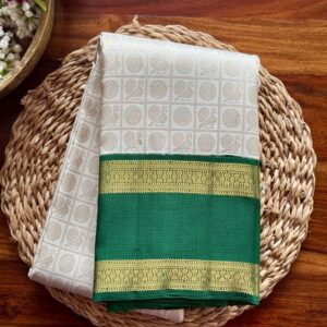 Sanghavi ivory silk saree with emerald green 3g pure gold zari border.