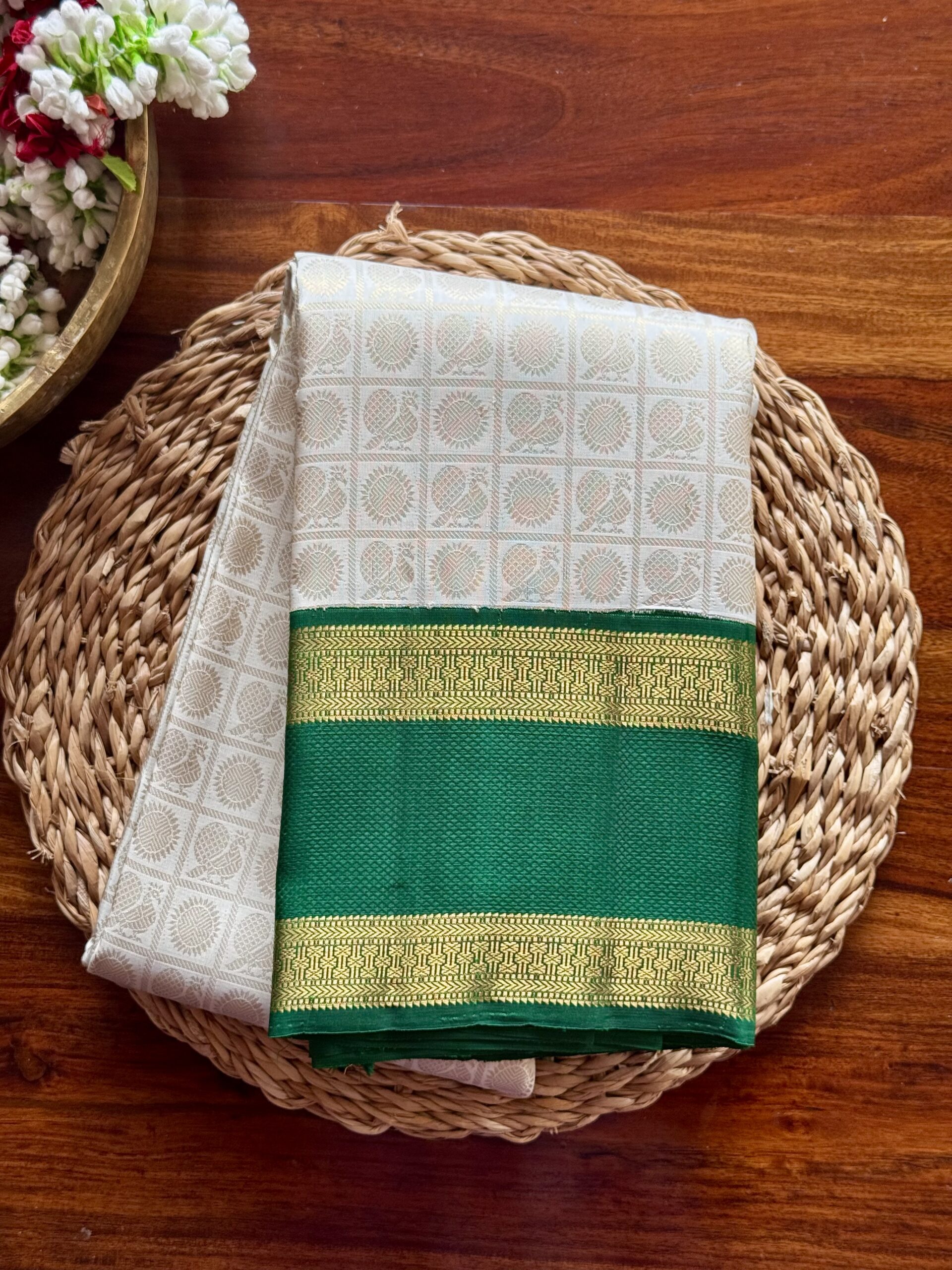 Sanghavi ivory silk saree with emerald green 3g pure gold zari border.
