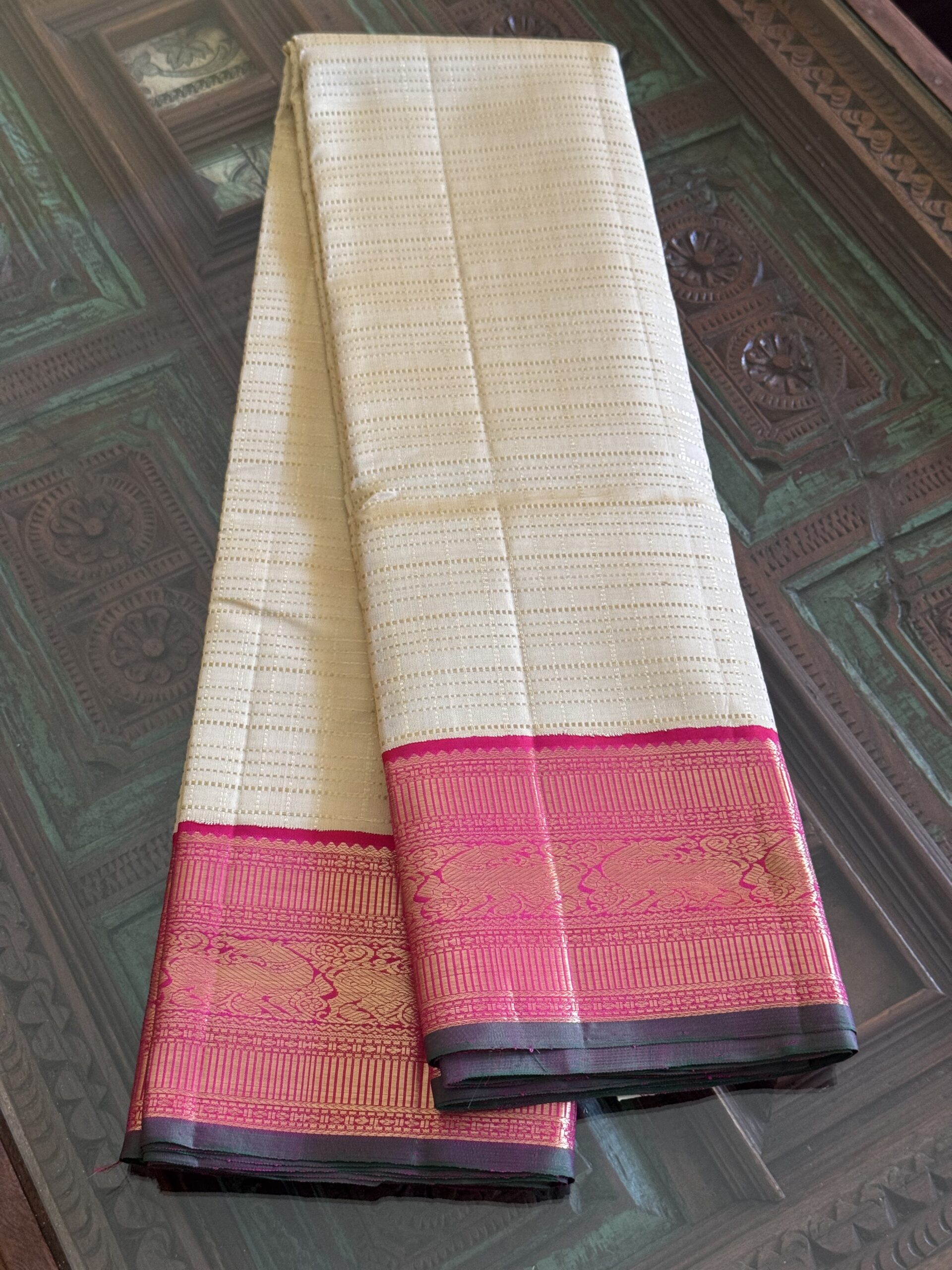 Sidhika silk saree featuring 2g gold zari and a hand-woven pallu with green selvedge.