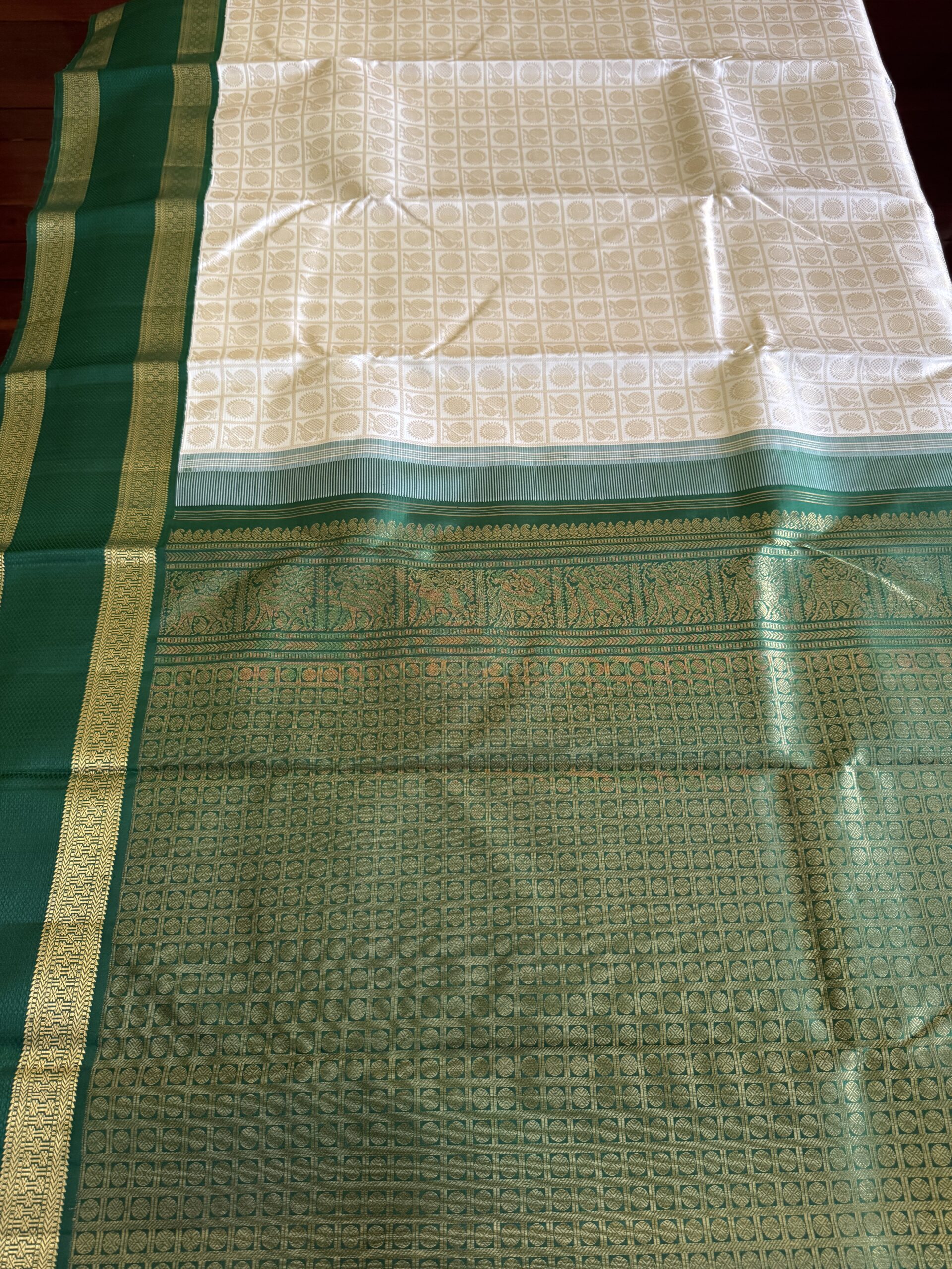 Detail of Annam and Chakram 3g zari motifs on ivory handloom silk.