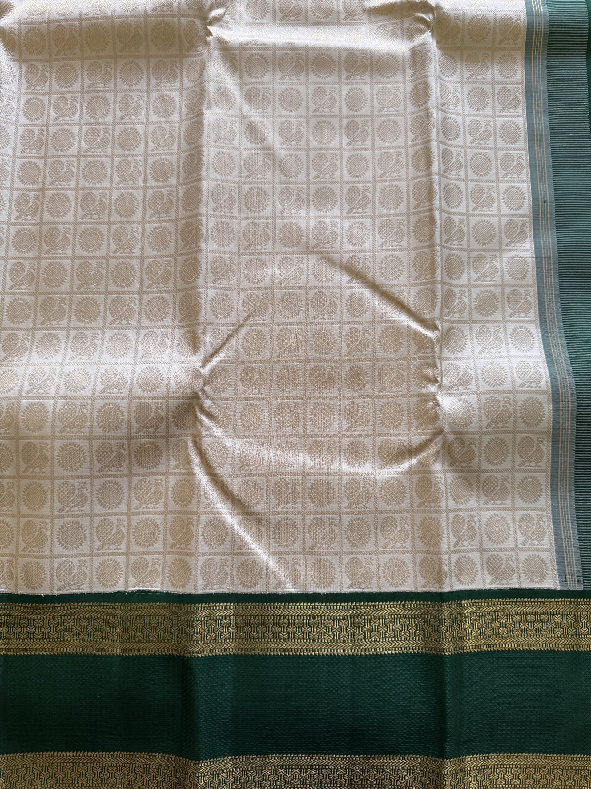 Detail of Annam and Chakram 3g zari motifs on ivory handloom silk.