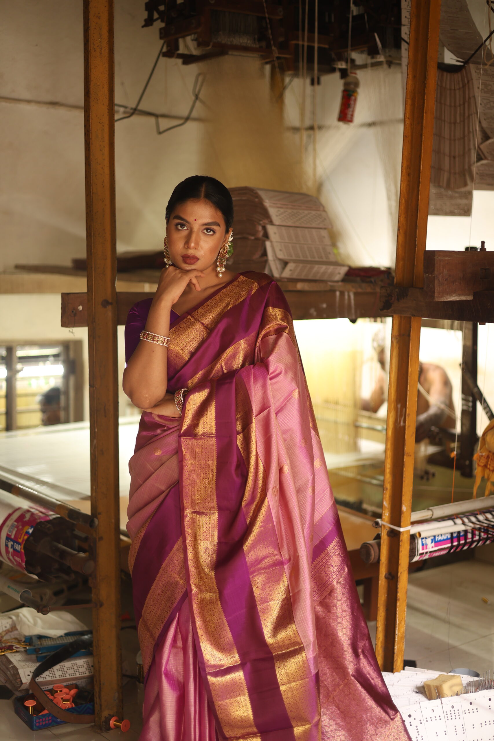 Oviya onion pink Kanjivaram silk saree with woven micro-checks and a deep magenta border.