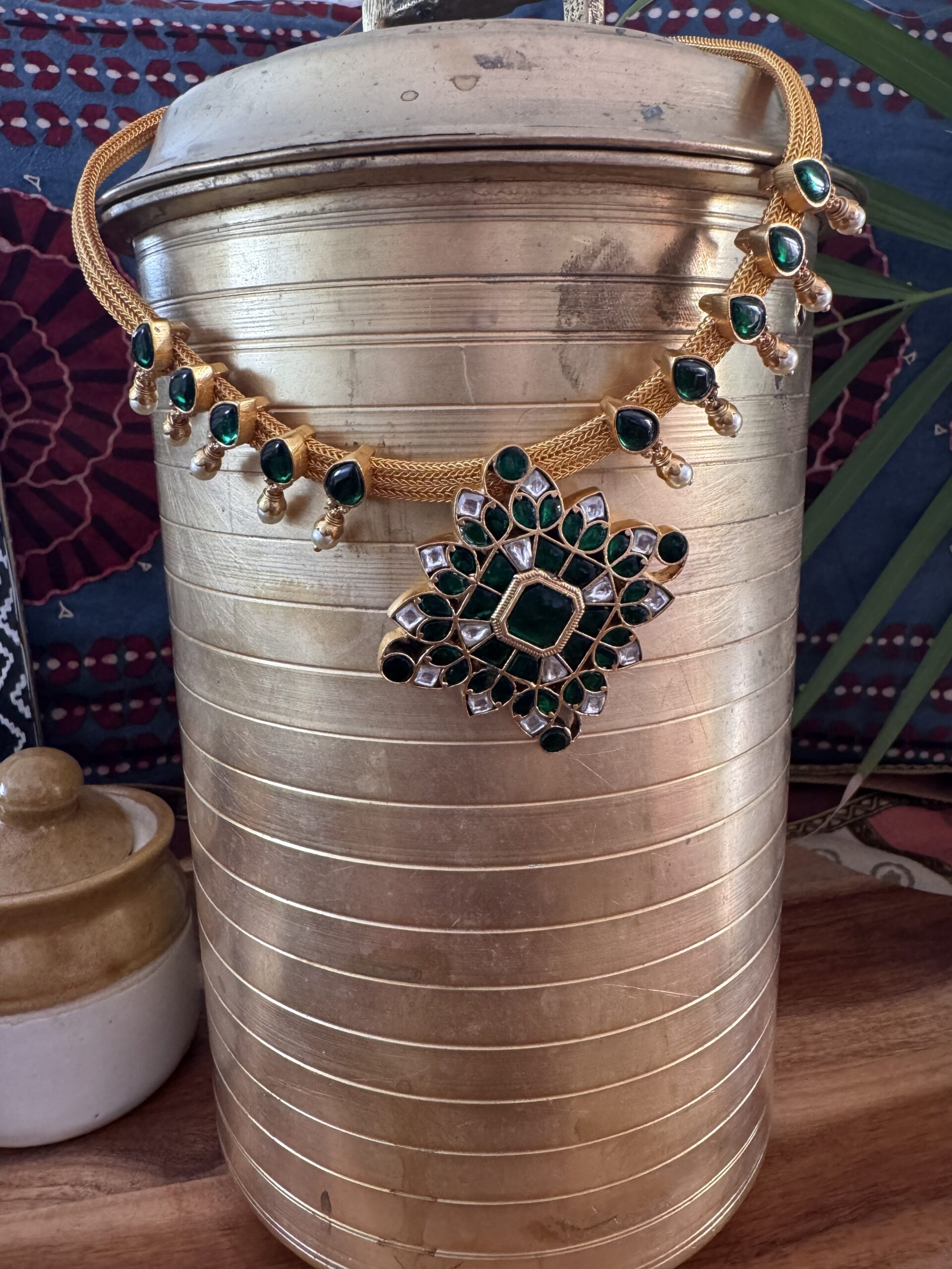 Green Jadau Kundan necklace on a gold cord.