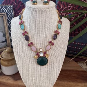 Colorful Jadau Kundan set with green pendant and earrings.