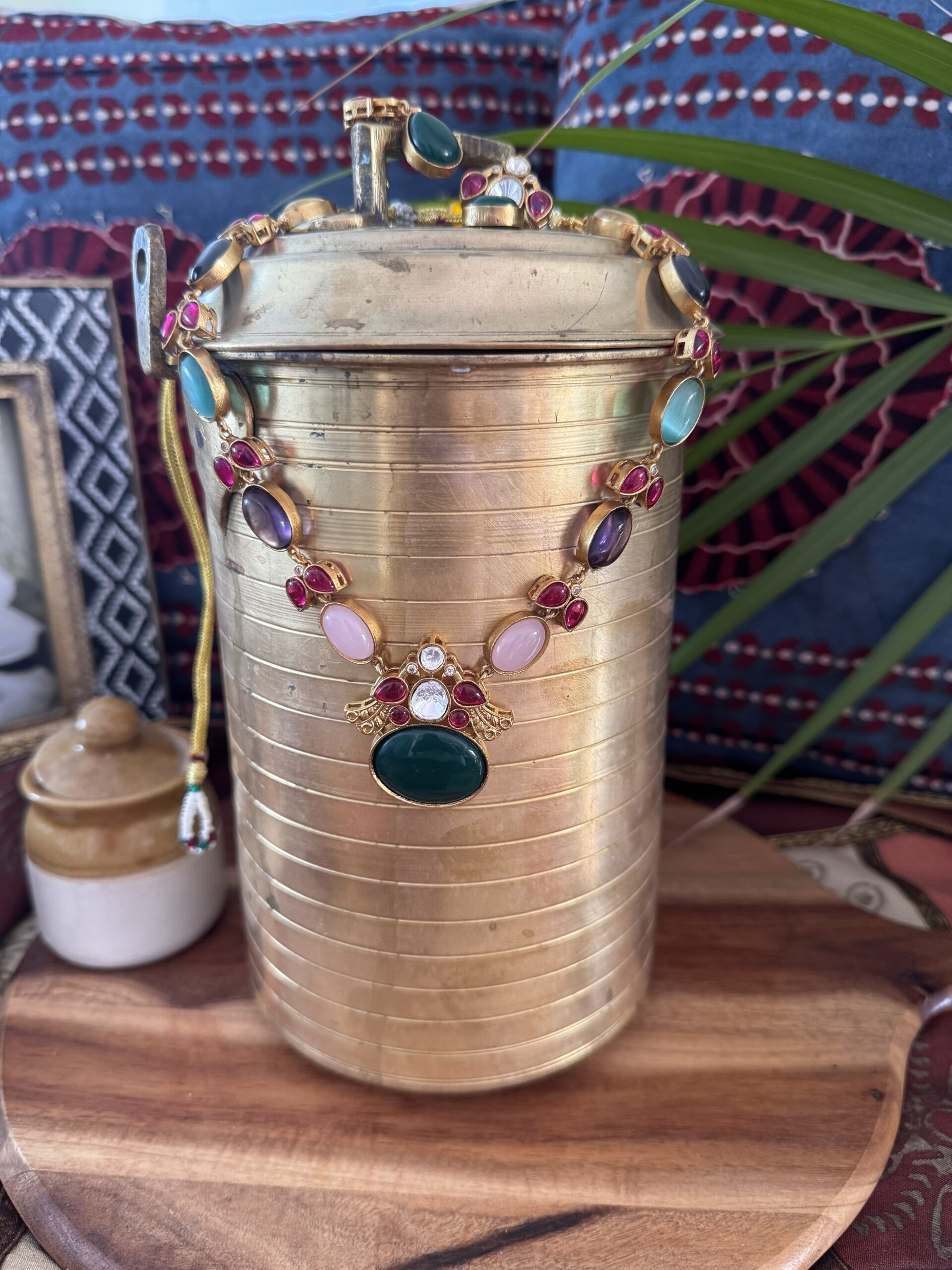 Colorful Jadau Kundan set with green pendant and earrings.
