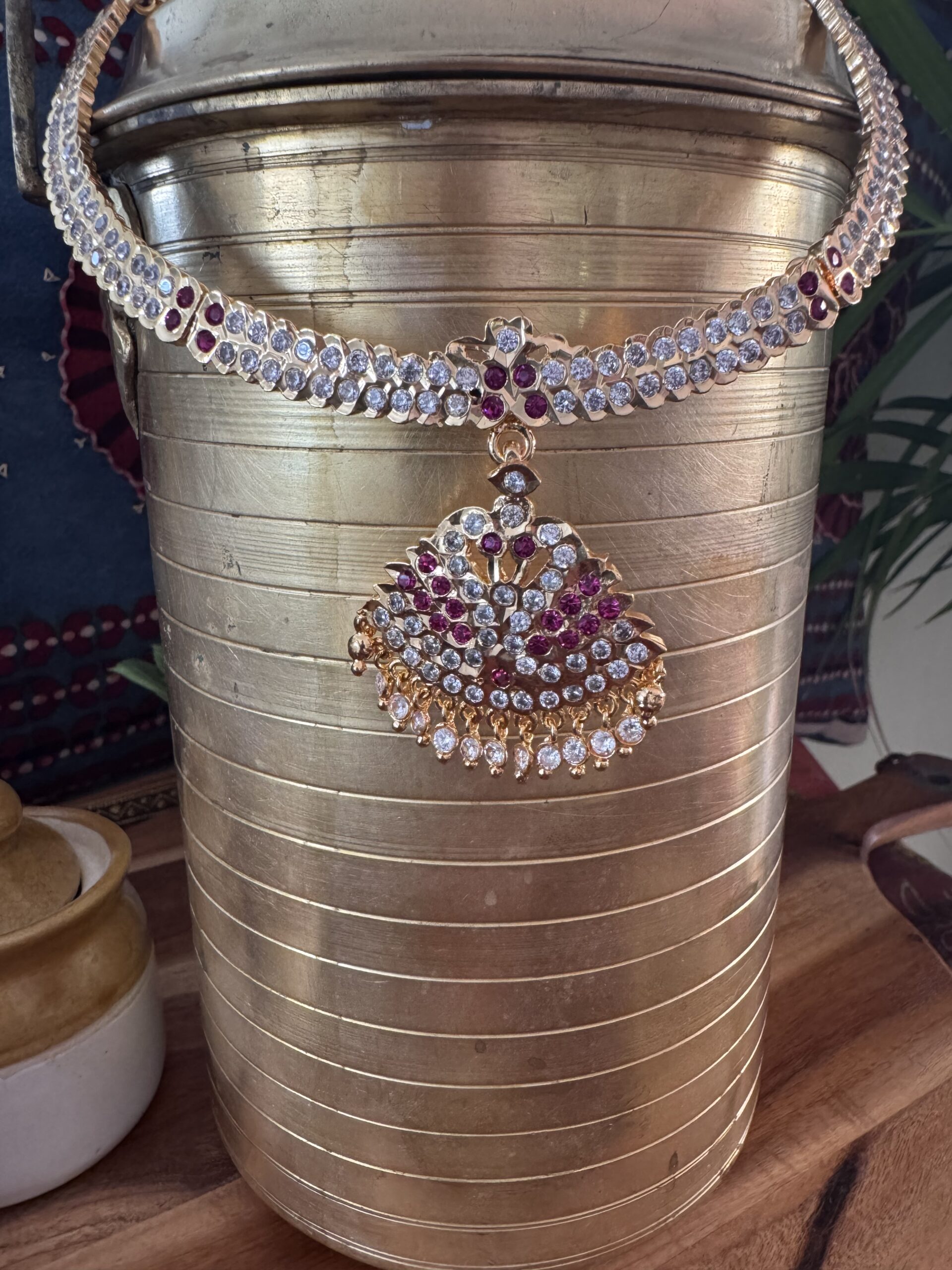Impon Attigai necklace set with Jhumka earrings and red stones.