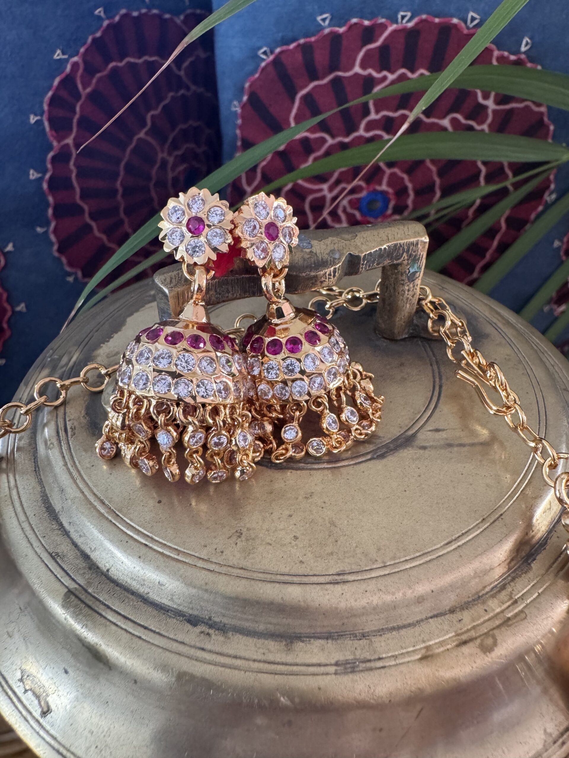 Impon Attigai necklace set with Jhumka earrings and red stones.