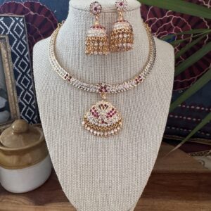 Impon Attigai necklace set with Jhumka earrings and red stones.