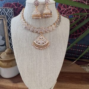 Traditional gold-toned Impon attigai necklace with clear white stones.