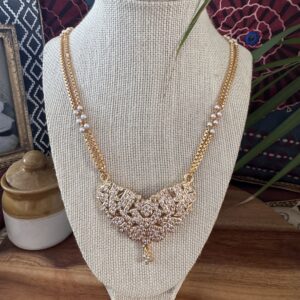 Floral-inspired gold-toned Impon necklace with white stone clusters and a pearl-accented dual chain.