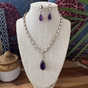 Silver-toned Victorian necklace set with deep purple teardrop pendant and matching earrings.