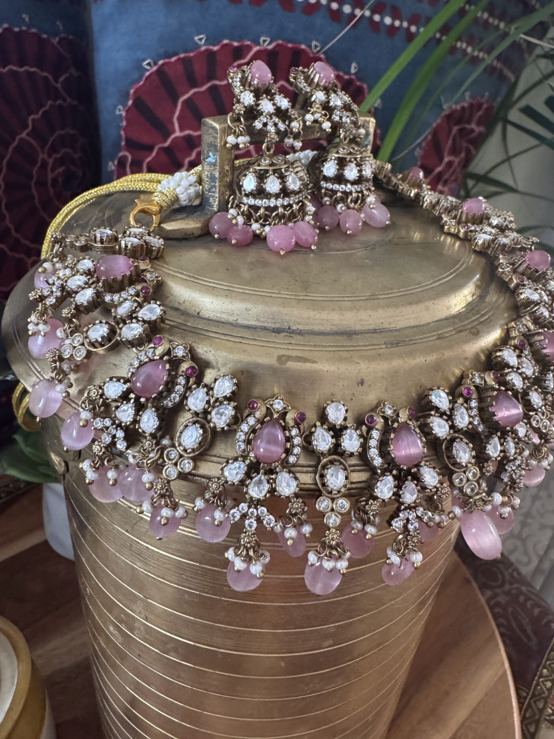 Gold-toned Victorian necklace with pink and white stones and matching earrings.