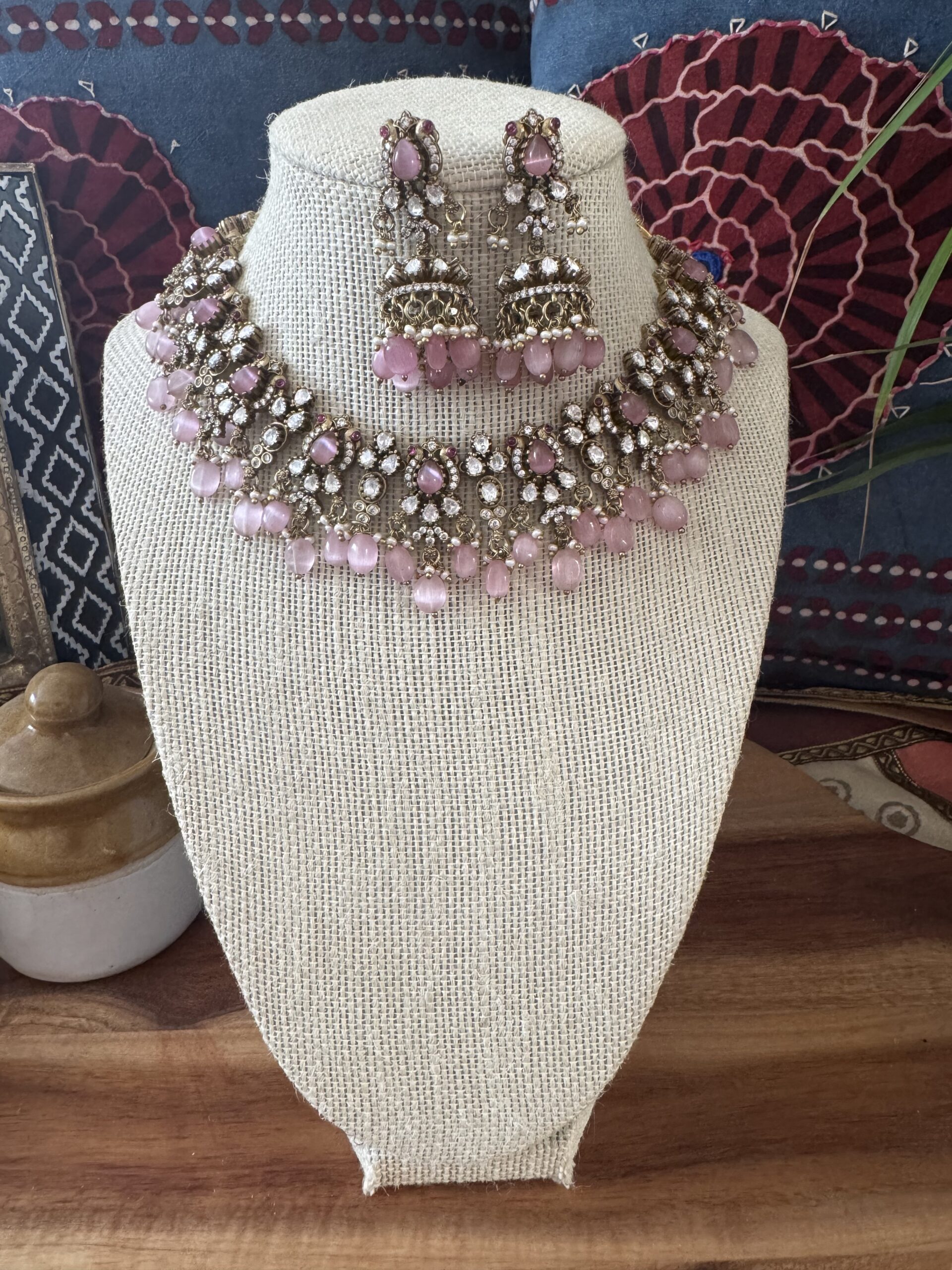 Gold-toned Victorian necklace with pink and white stones and matching earrings.