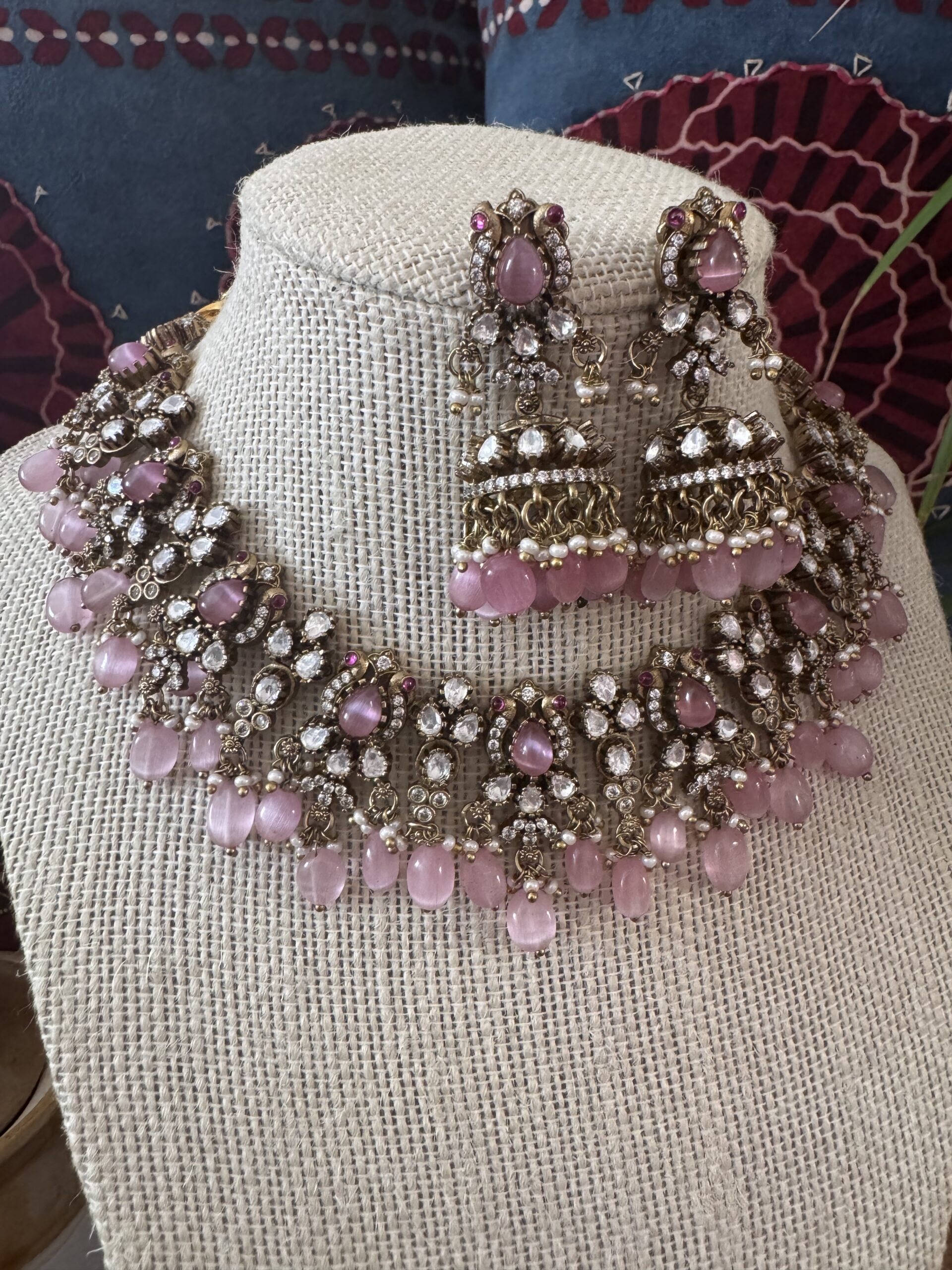 Gold-toned Victorian necklace with pink and white stones and matching earrings.