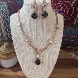 Gold-toned Victorian necklace with a black quartz teardrop and clear stones.
