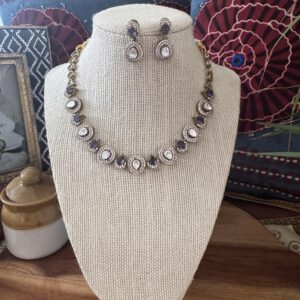 Gold-toned Victorian necklace with lavender and white stones and matching earrings.