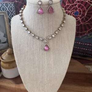 Gold-toned necklace with a pink and green Kundan pendant and pearl drops.