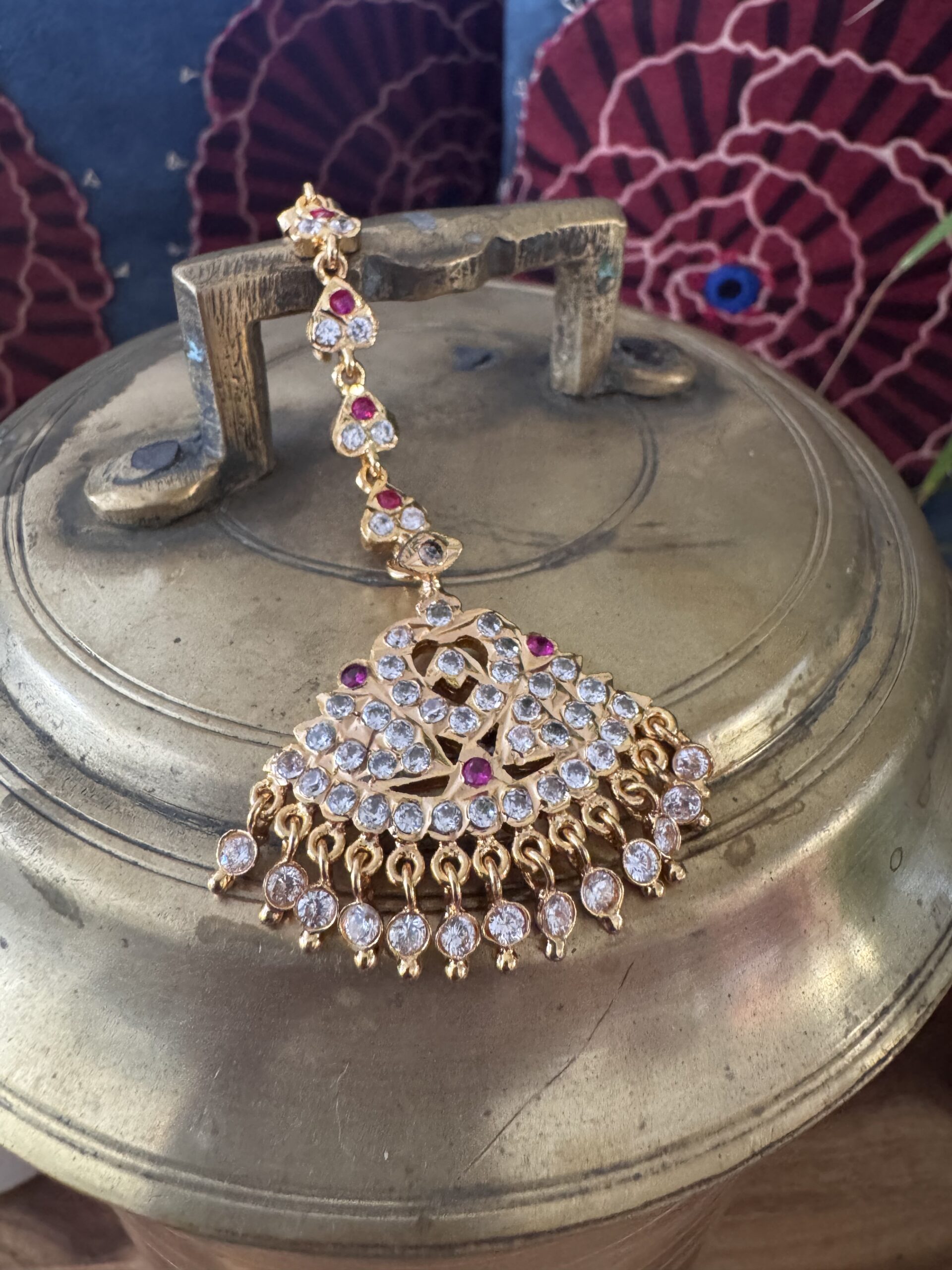 Gold-toned Nethi Chutti with clear and ruby stones