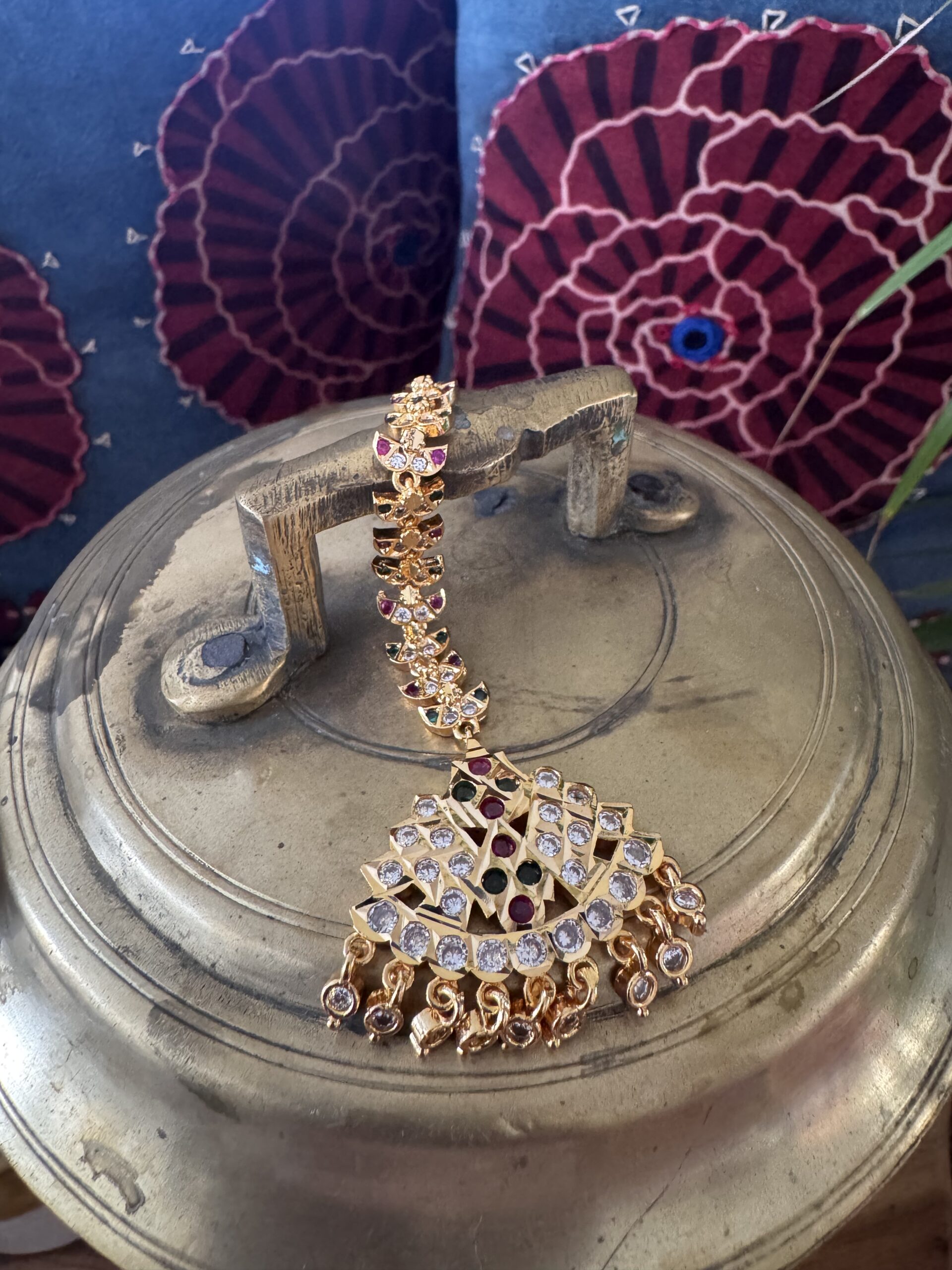 Gold-toned Nethi Chutti with clear and ruby stones