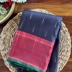 Handloom black Kanjivaram silk saree with maroon border and green selvedge.