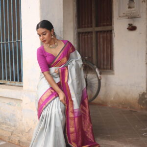 Hand-woven dove grey Kanjivaram silk saree featuring a magenta border and 1g zari detail.