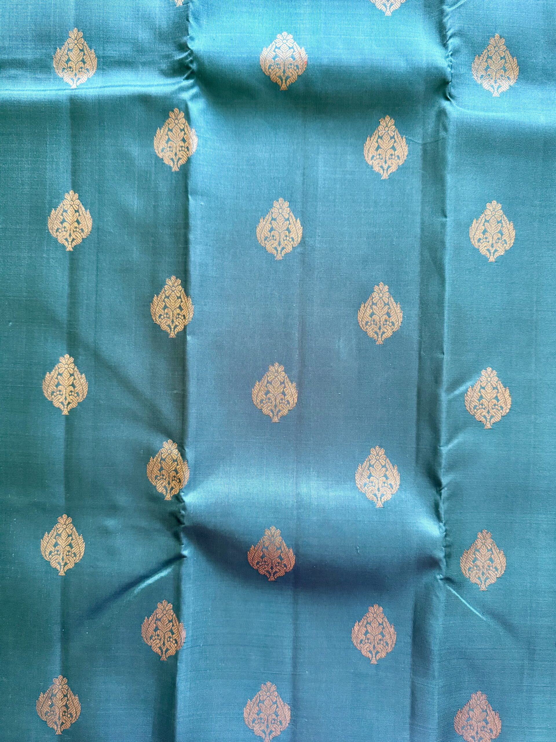 Hamsini teal blue pure Kanjivaram silk saree with all-over zari motifs and a golden yellow 3g zari pallu.