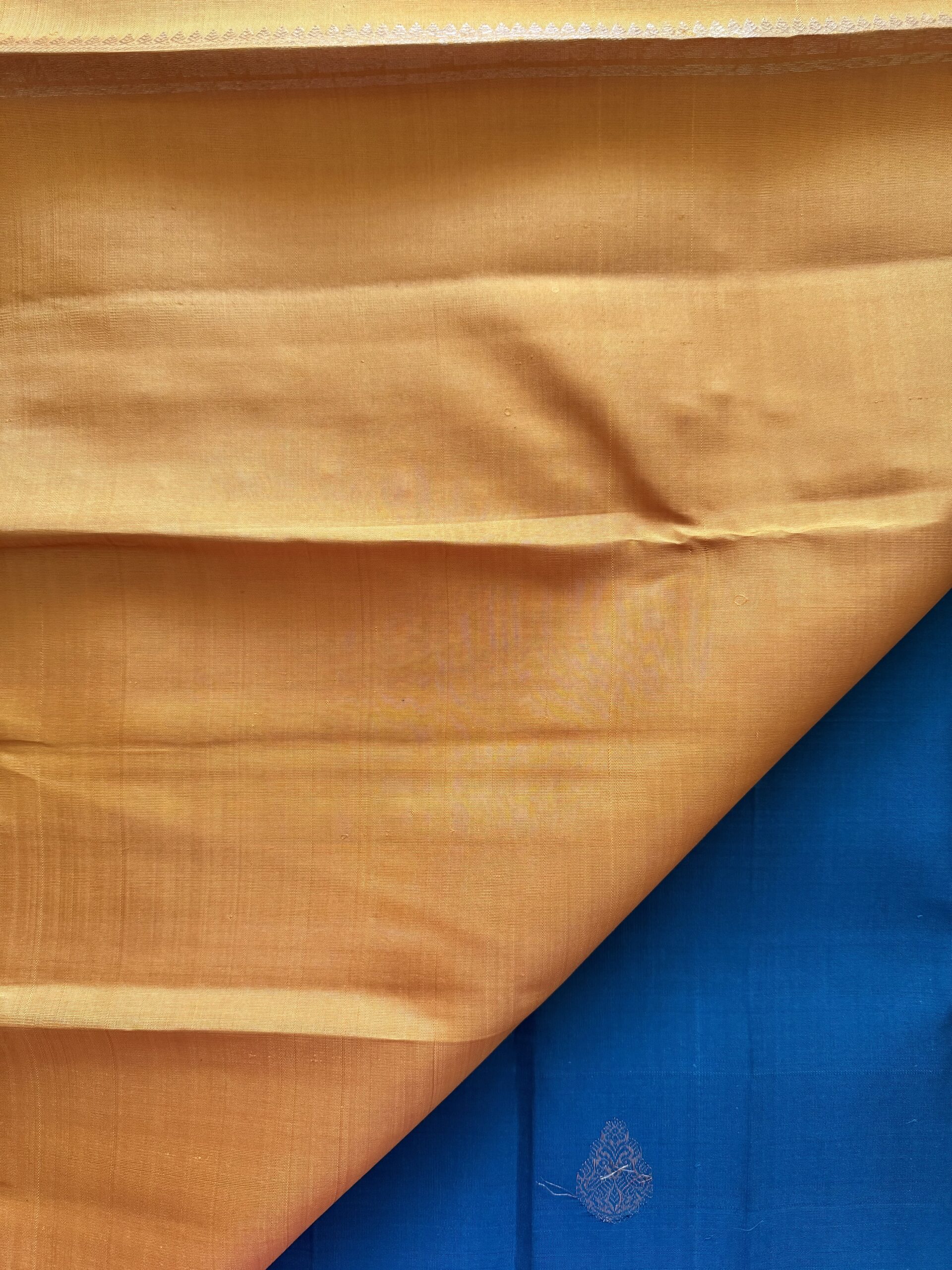 Hamsini teal blue pure Kanjivaram silk saree with all-over zari motifs and a golden yellow 3g zari pallu.