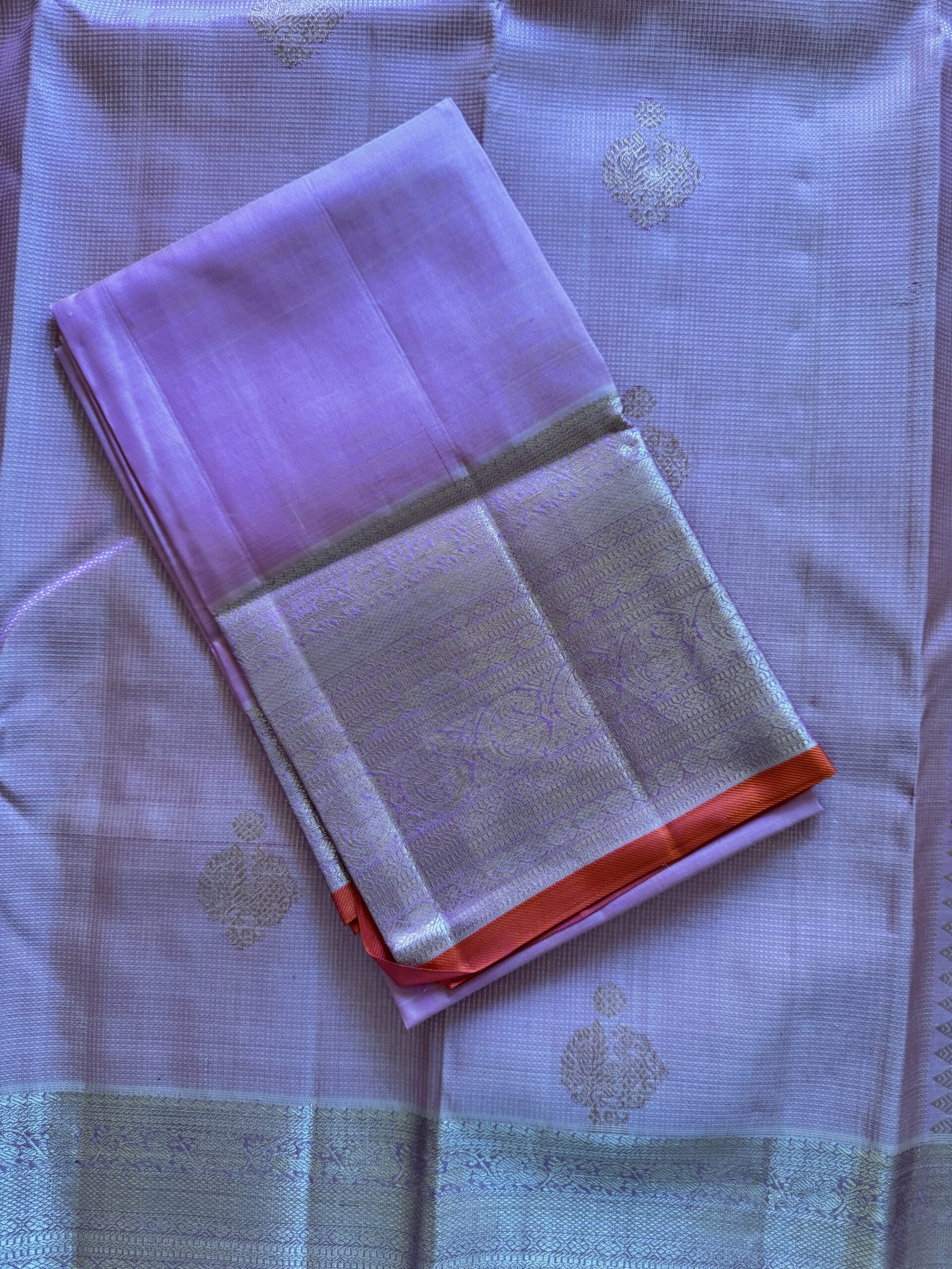 Amara pink and onion shot Kanjivaram silk saree with zari checks and mango and annam motif borders.