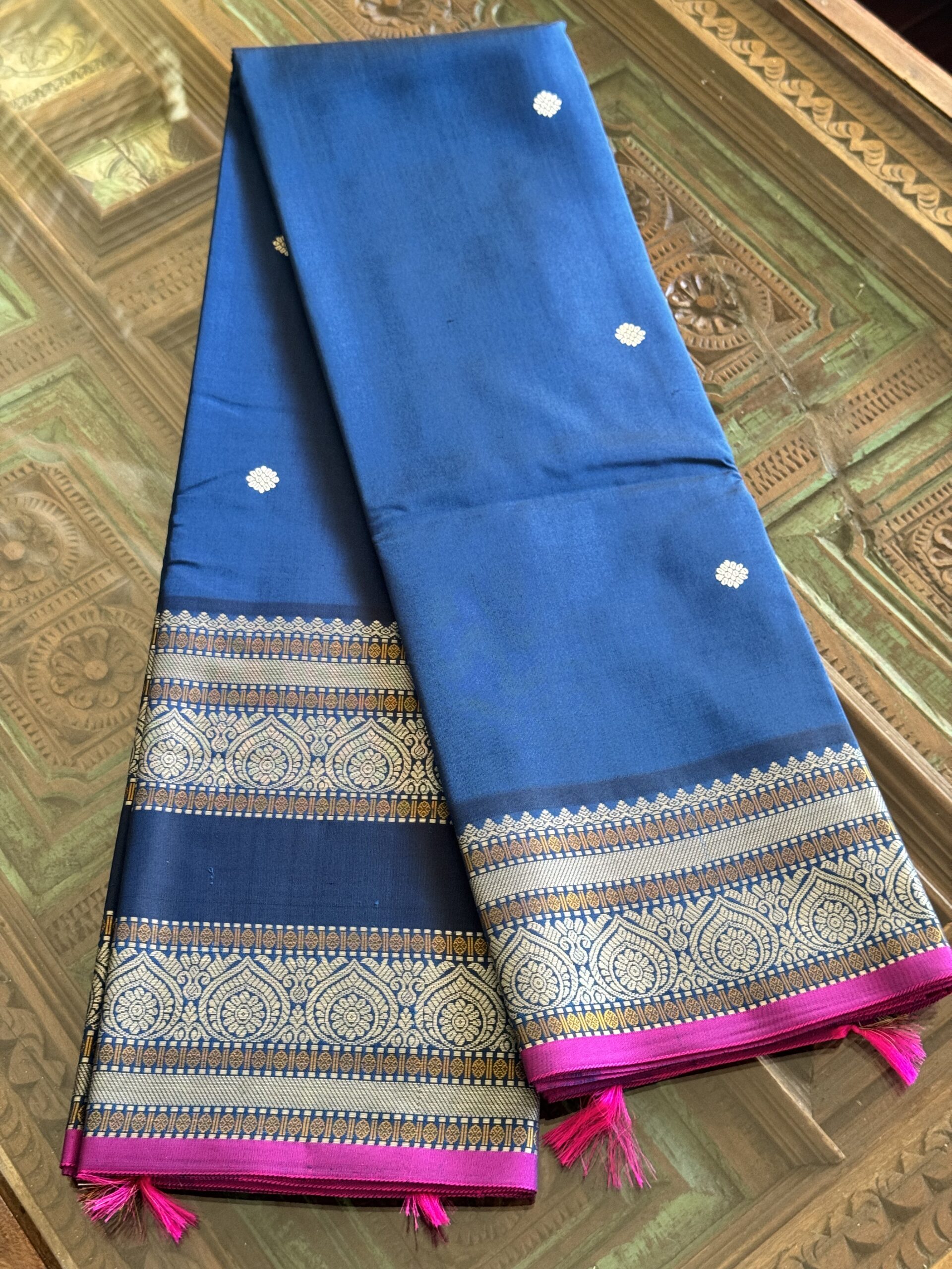 Meera dark blue shot Kanjivaram silk saree with asymmetrical threadwork borders and magenta selvage.