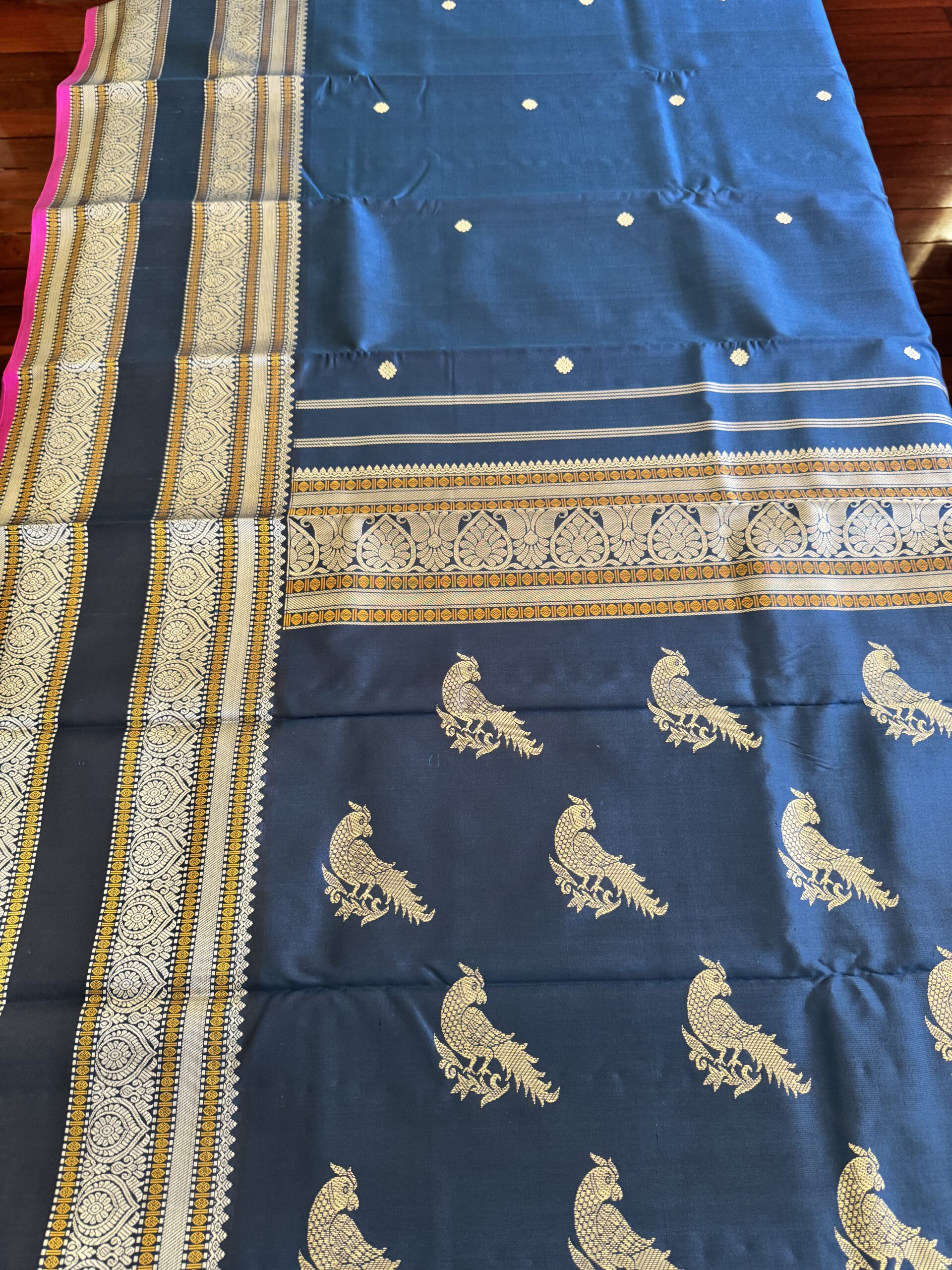 Meera dark blue shot Kanjivaram silk saree with asymmetrical threadwork borders and magenta selvage.