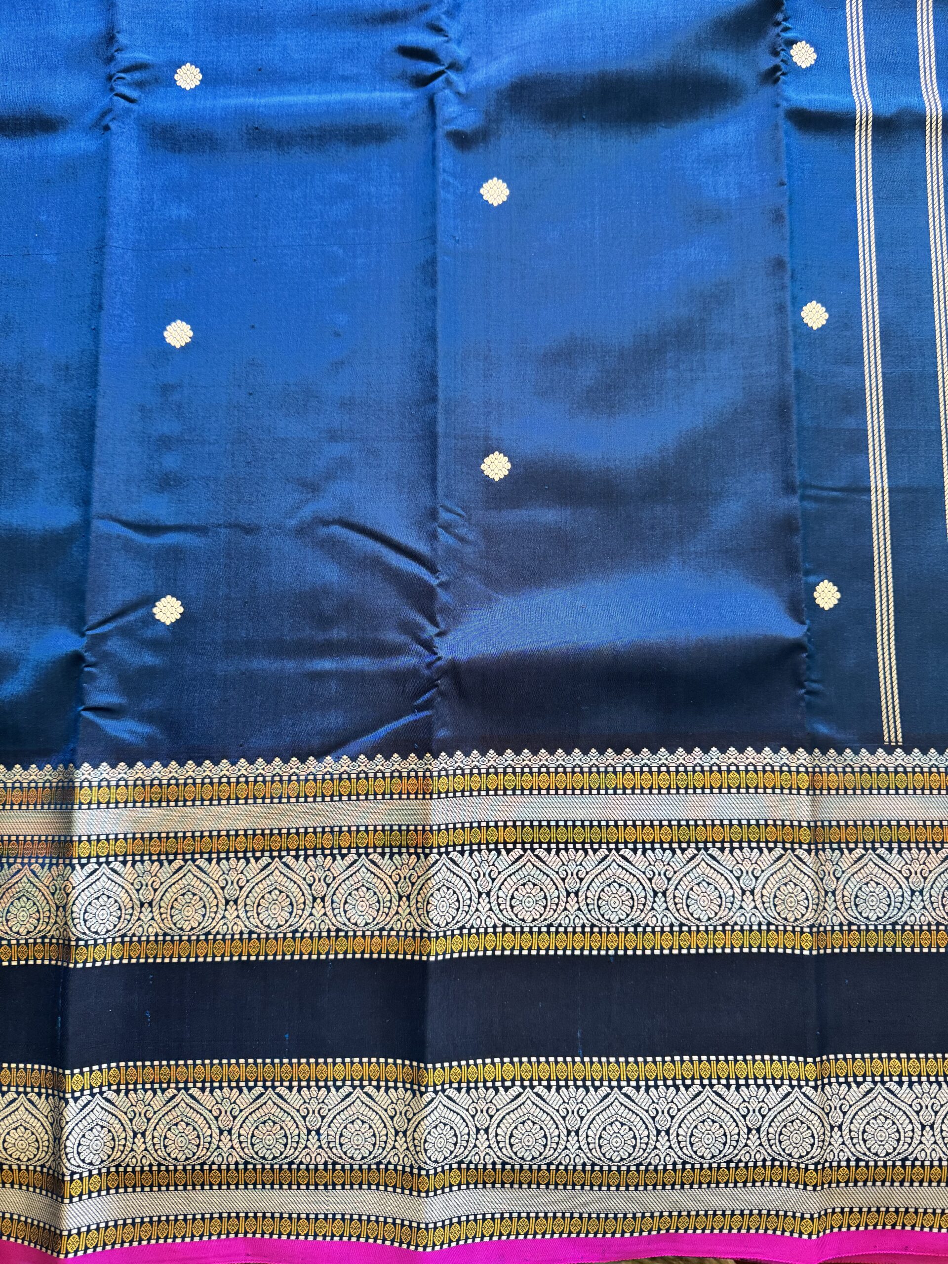 Meera dark blue shot Kanjivaram silk saree with asymmetrical threadwork borders and magenta selvage.