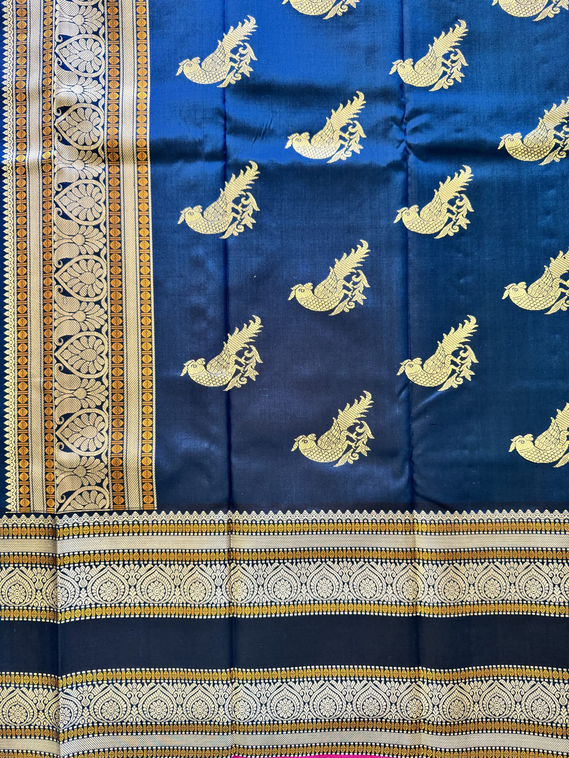 Meera dark blue shot Kanjivaram silk saree with asymmetrical threadwork borders and magenta selvage.