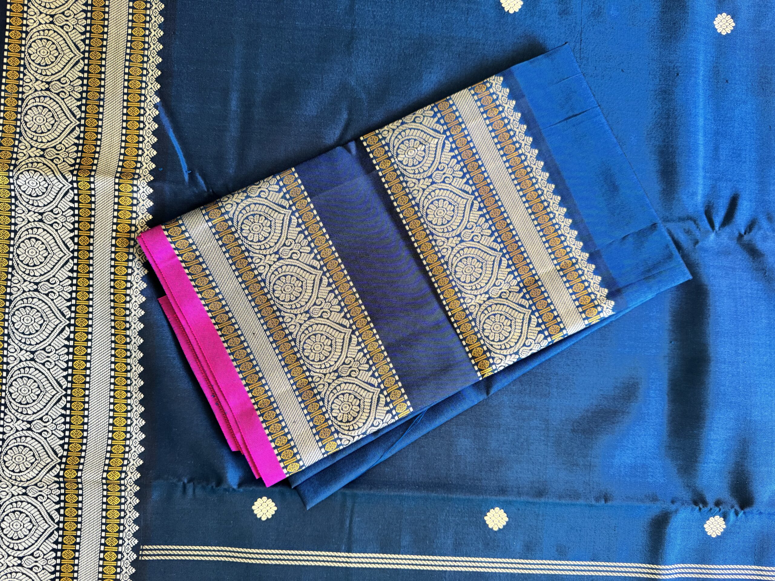 Meera dark blue shot Kanjivaram silk saree with asymmetrical threadwork borders and magenta selvage.