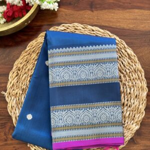 Meera dark blue shot Kanjivaram silk saree with asymmetrical threadwork borders and magenta selvage.