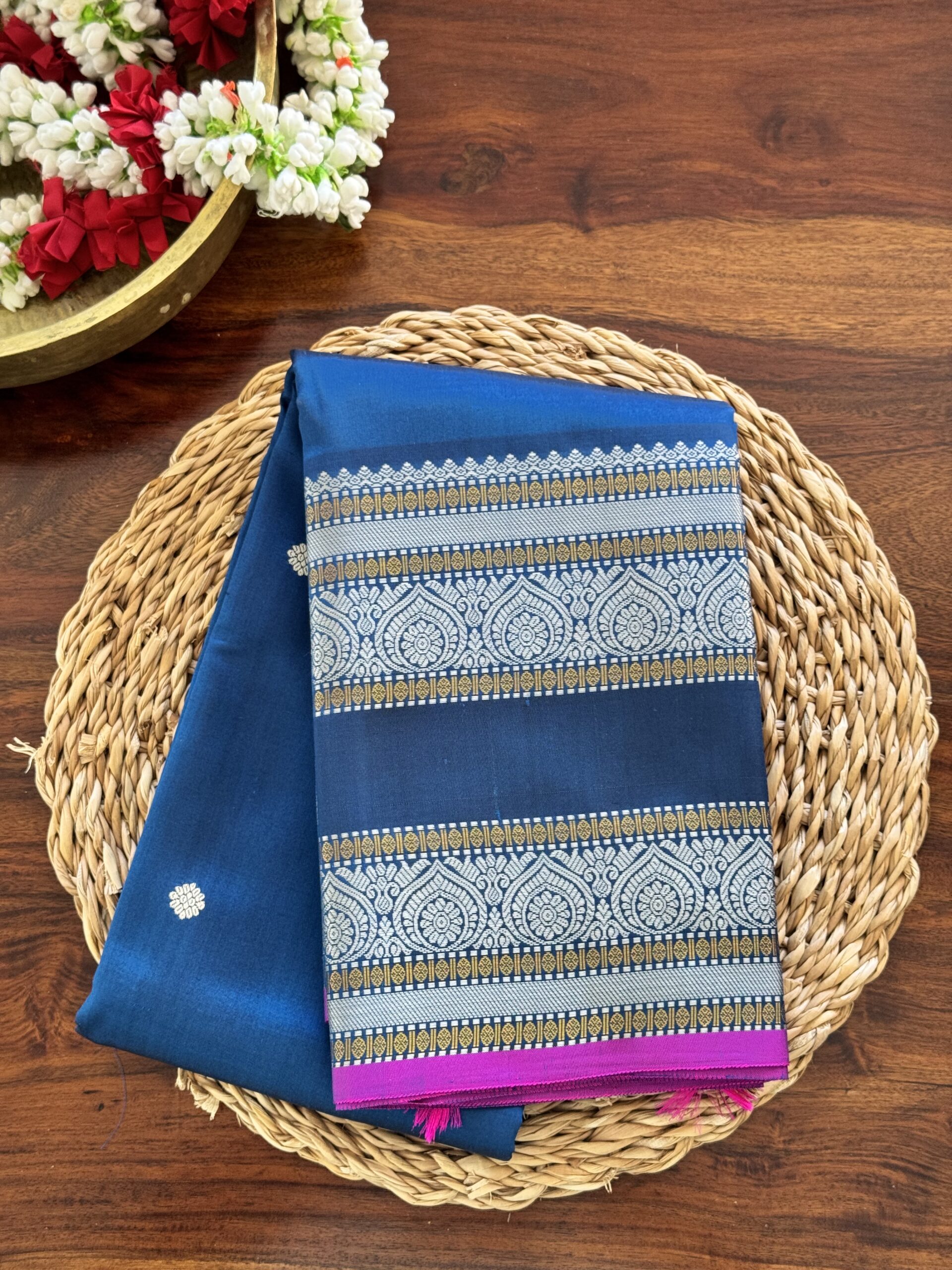 Meera dark blue shot Kanjivaram silk saree with asymmetrical threadwork borders and magenta selvage.