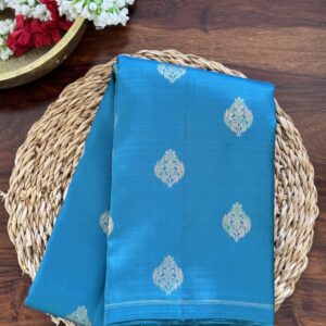 Hamsini teal blue pure Kanjivaram silk saree with all-over zari motifs and a golden yellow 3g zari pallu.