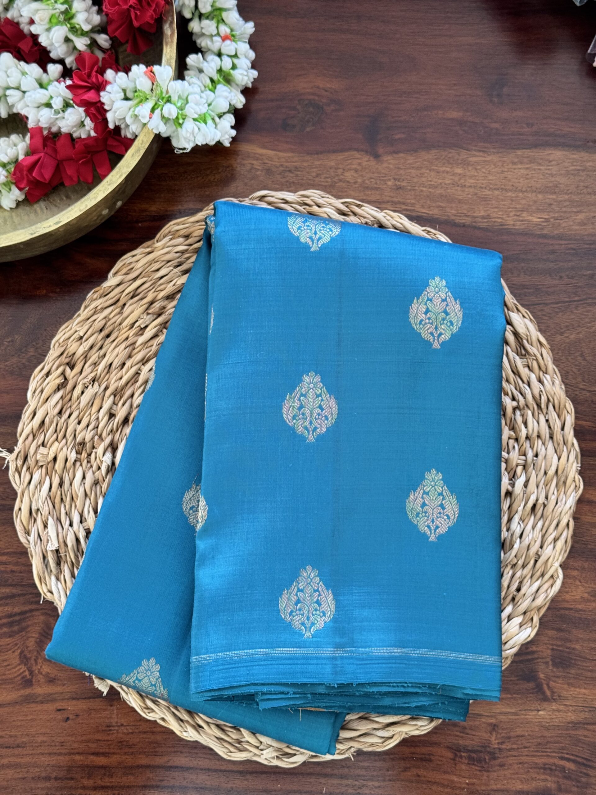 Hamsini teal blue pure Kanjivaram silk saree with all-over zari motifs and a golden yellow 3g zari pallu.