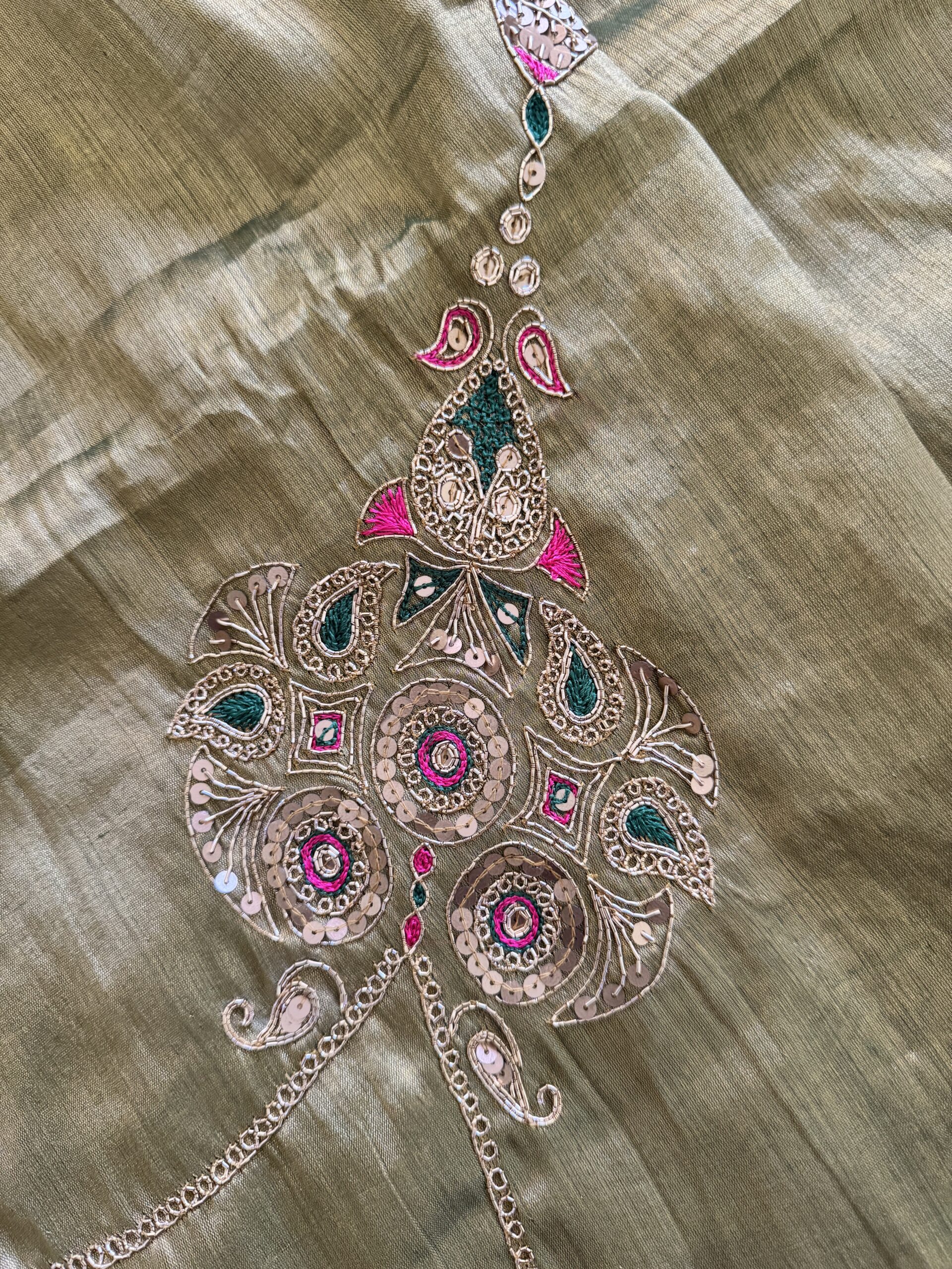 Close-up of hand-embroidered peacock pallu motif on Suvarna gold tissue silk saree — gold zari, emerald green thread, pink sequin and mirror work by Tari by Gayatri