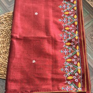 Vanamaala brick red handwoven tissue silk saree folded, showing full hand-embroidered multicolour floral garden border with mustard yellow piping — Tari by Gayatri