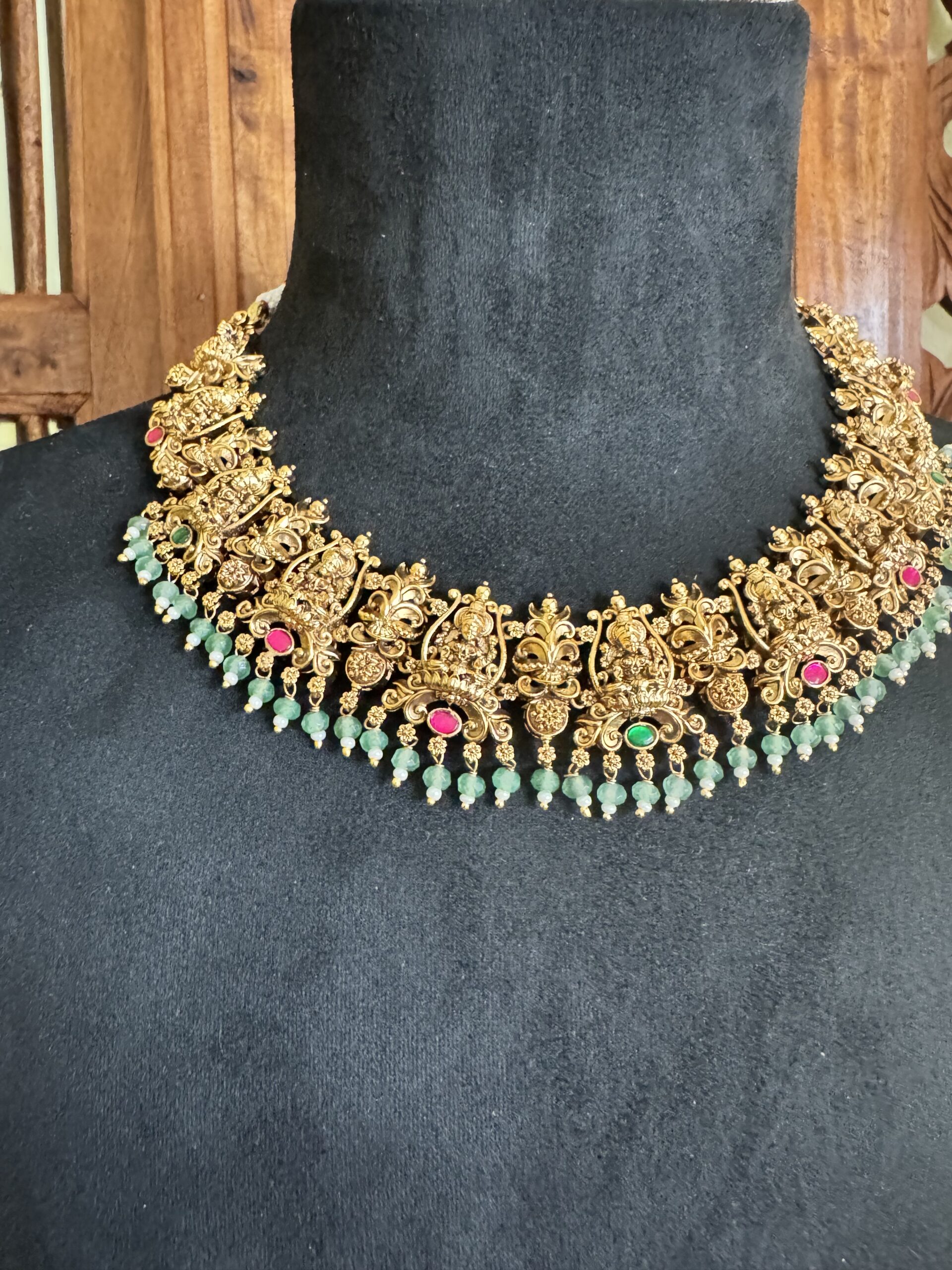 ROOR traditional temple jewellery set featuring an antique gold necklace and matching jhumki earrings with light green beads