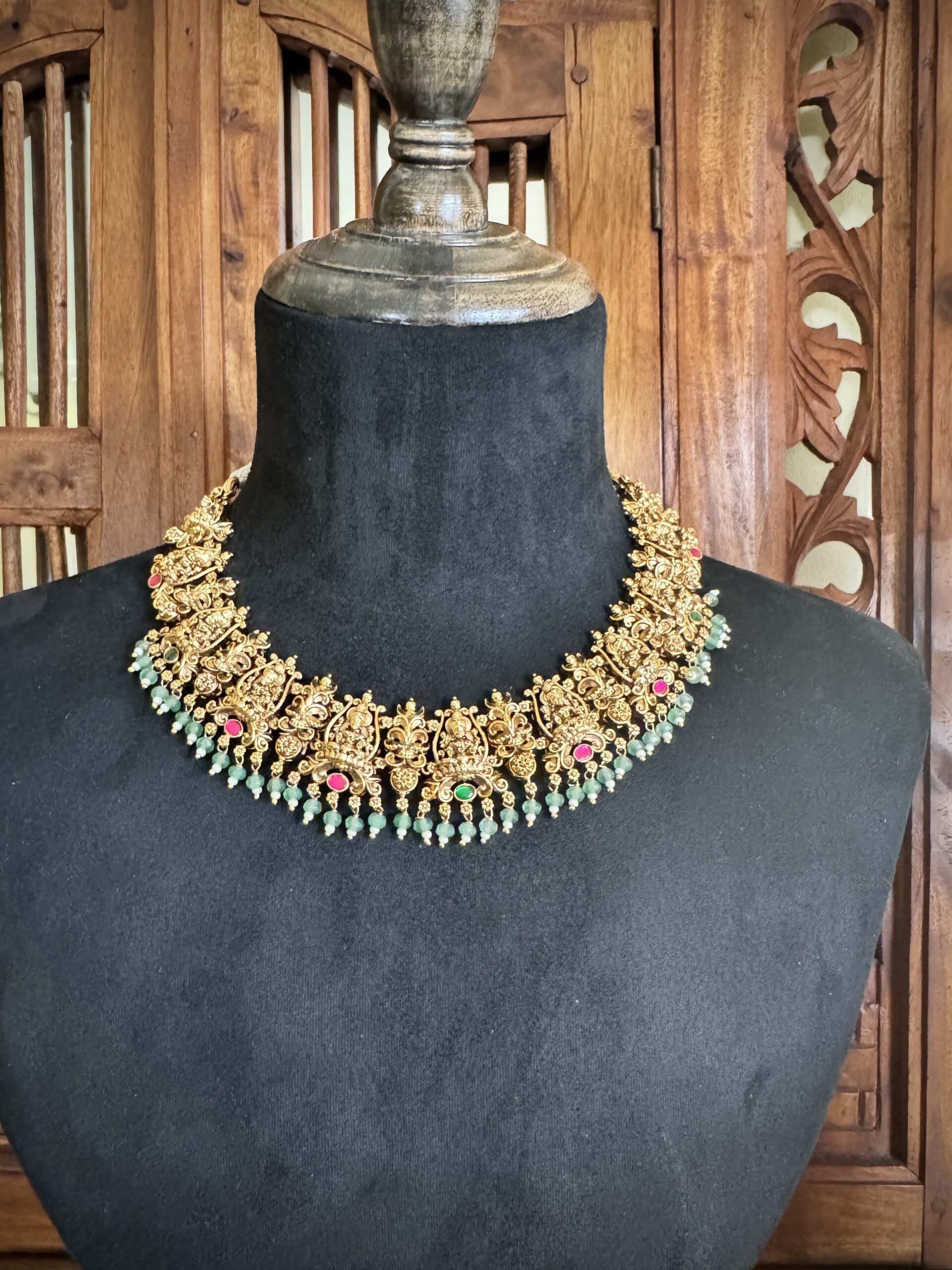 ROOR traditional temple jewellery set featuring an antique gold necklace and matching jhumki earrings with light green beads