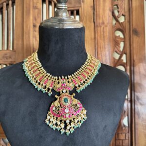 IBIT traditional temple necklace with a large peacock pendant and matching pink jhumki earrings with green bead drops