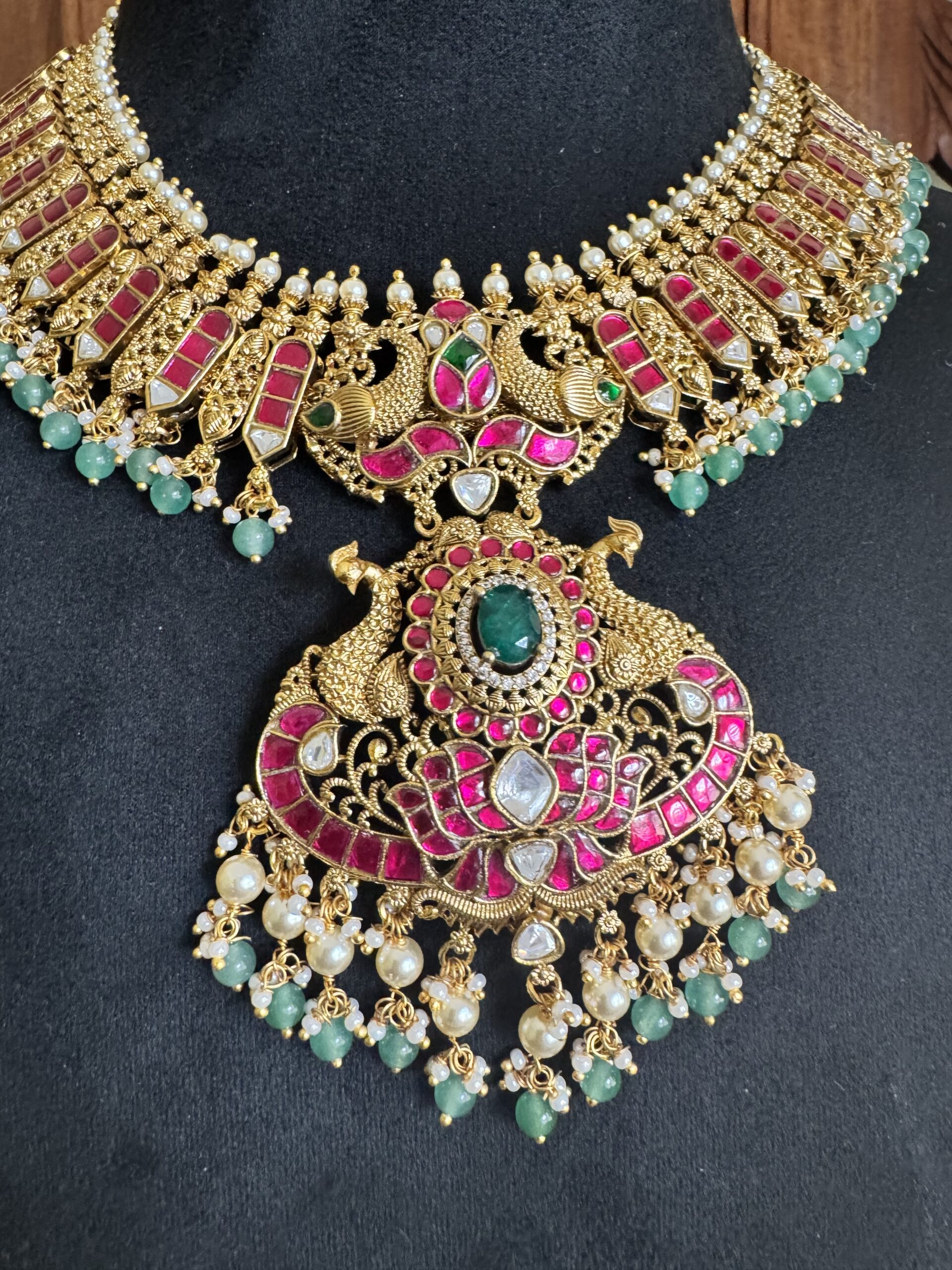 IBIT traditional temple necklace with a large peacock pendant and matching pink jhumki earrings with green bead drops