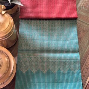 Kalyani brown rust shot soft silk saree with gold zari checks and a sea green pallu with tassels.