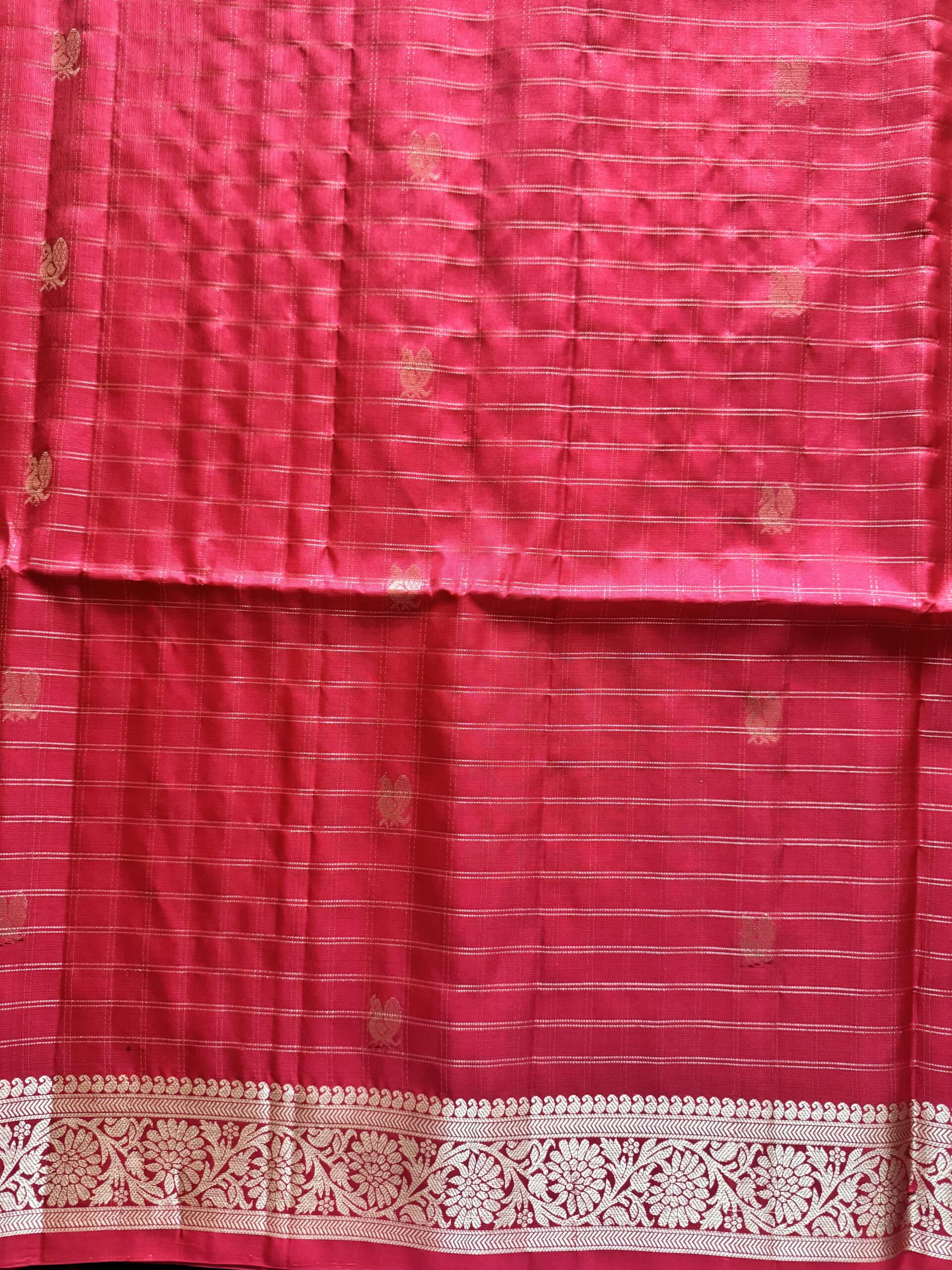 Nandini tomato red soft silk saree with gold zari checks and a peacock pallu with tassels.