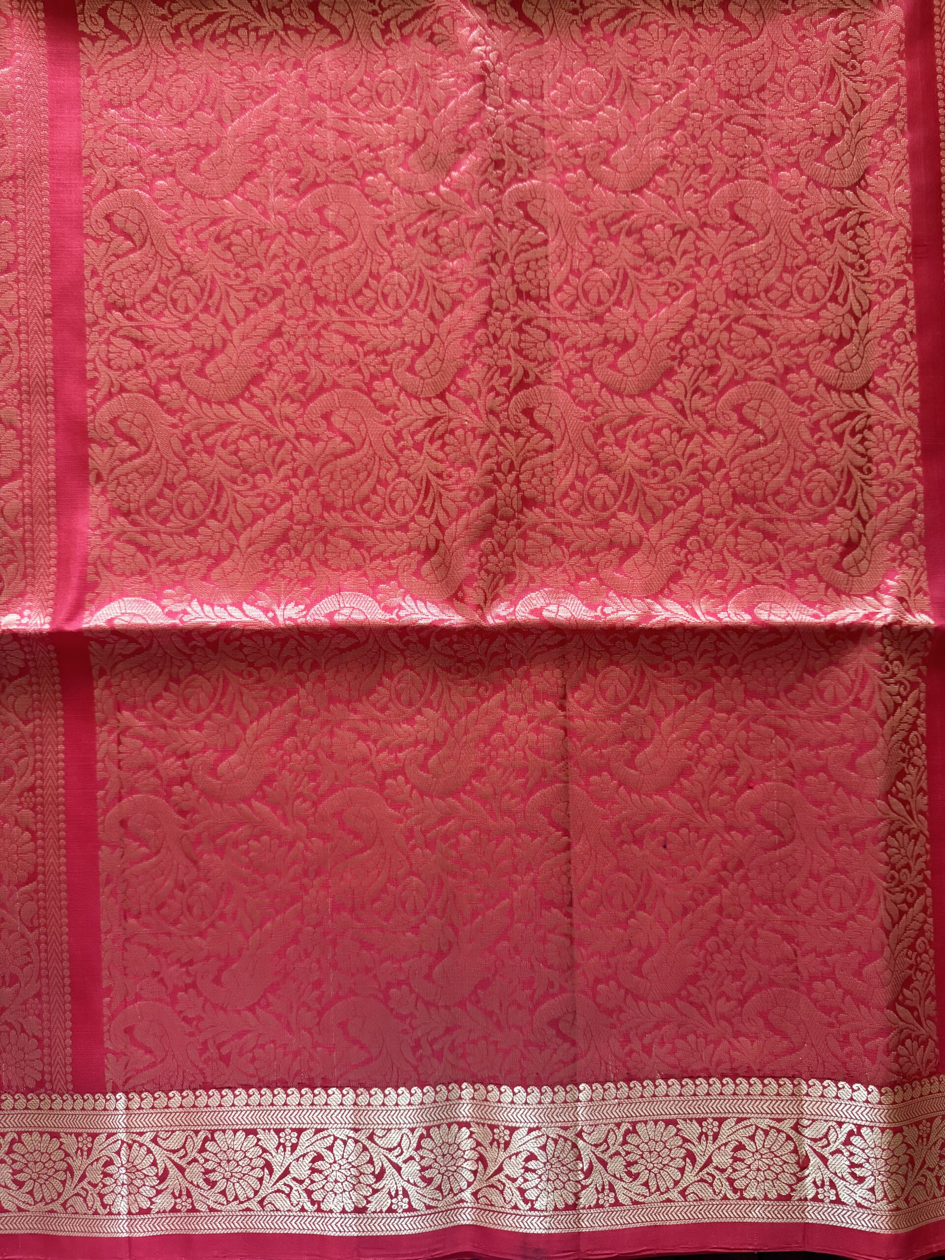 Nandini tomato red soft silk saree with gold zari checks and a peacock pallu with tassels.