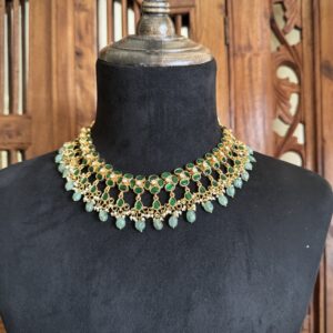 Traditional green kundan necklace and jhumki earrings set with light green bead drops