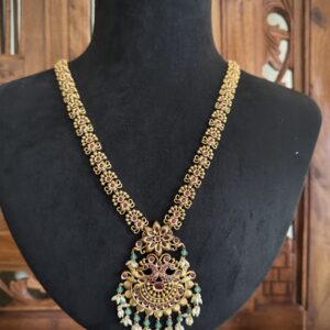 RKBI traditional antique gold long haaram necklace with a large peacock pendant and matching dome jhumka earrings